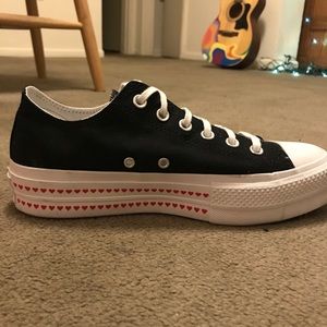 Black Chuck Taylor Converse, platform with hearts.